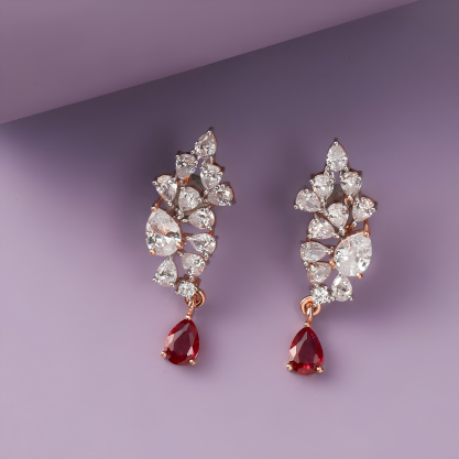 Pair of silver-toned earrings with red teardrop gemstones.