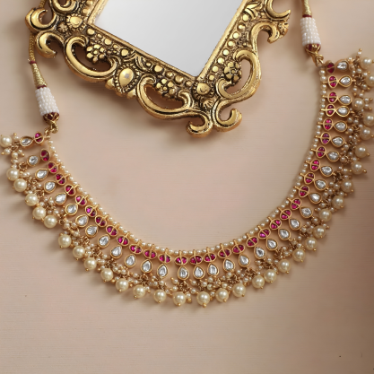 Gold-plated Jadau silver choker necklace with pearls and red stones.