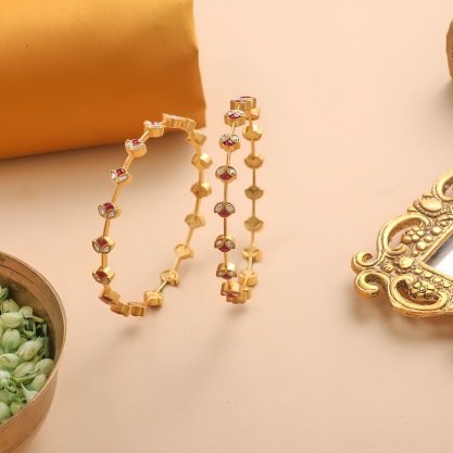 Traditional gold bangles with colorful floral gemstones