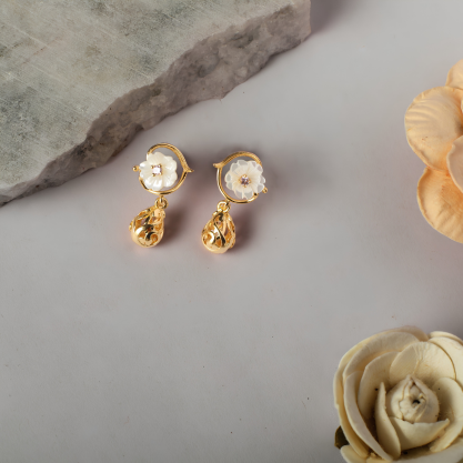Gold-toned floral drop earrings with pearl-like centers and delicate dangling details.