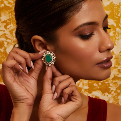 Woman wearing a green gemstone earring 